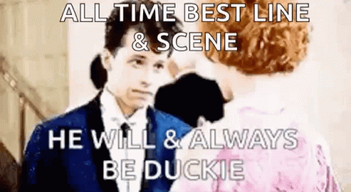 Man In Suit Talking To Woman In Pink Dress GIF