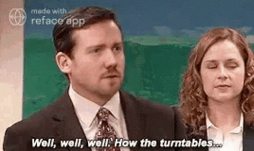 A Man In A Suit And Tie Is Standing Next To A Woman In A Suit And Tie . GIF