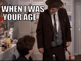 A Man In A Suit And Tie Is Standing Next To A Young Boy And Says When I Was Your Age GIF