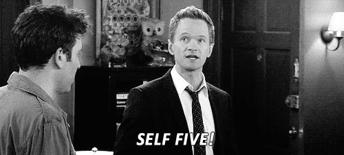 A Man In A Suit And Tie Is Standing Next To Another Man In A Room And Says `` Self Five '' . GIF