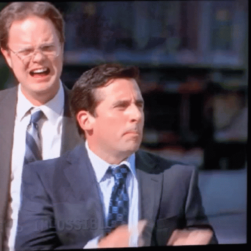 A Man In A Suit And Tie Is Standing Next To Another Man In A Suit And Tie With The Word Russell On The Bottom GIF