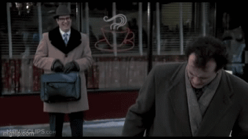 A Man In A Suit And Tie Is Standing Next To Another Man In A Suit And Tie . GIF