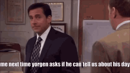 A Man In A Suit And Tie Is Standing Next To Another Man In An Office . GIF