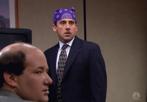 A Man In A Suit And Tie Is Standing Next To Another Man With A Nbc Logo On The Bottom Right GIF