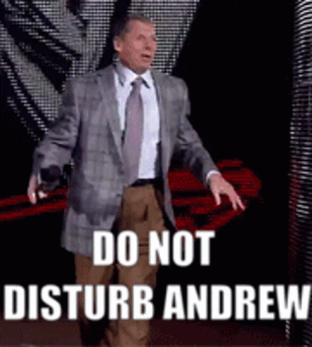 A Man In A Suit And Tie Is Standing On A Stage And Says Do Not Disturb Andrew GIF