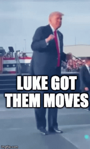 a man in a suit and tie is standing on a stage with the caption luke got them moves