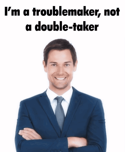 A Man In A Suit And Tie Is Standing With His Arms Crossed And Says I 'M A Troublemaker Not GIF