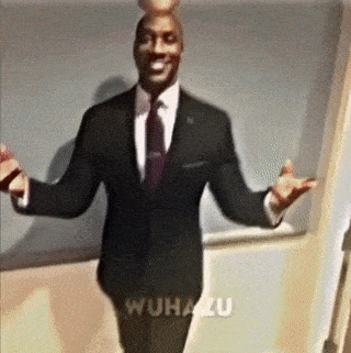 A Man In A Suit And Tie Is Standing With His Arms Outstretched In Front Of A Wall That Says Wuhanzu GIF