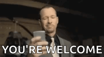 A Man In A Suit And Tie Is Taking A Picture Of Himself With His Cell Phone . GIF