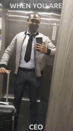 A Man In A Suit And Tie Is Taking A Selfie In An Elevator With The Caption When You Are Ceo . GIF