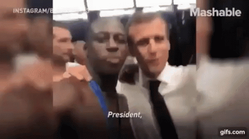 A Man In A Suit And Tie Is Taking A Selfie With A Man In A Suit And Tie . GIF