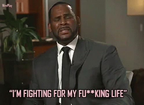 A Man In A Suit And Tie Is Talking About Fighting For His King Life . GIF