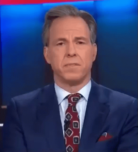 A Man In A Suit And Tie Is Talking About Something That Was A Hot Mess Inside A Dumpster GIF