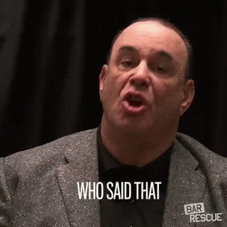 A Man In A Suit And Tie Is Talking And Saying `` Who Said That '' . GIF