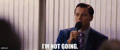 A Man In A Suit And Tie Is Talking Into A Microphone And Saying `` I 'M Not Going '' . GIF