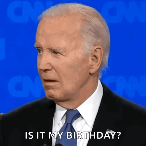 A Man In A Suit And Tie Is Talking Into A Microphone And Saying `` Is It My Birthday ? '' GIF