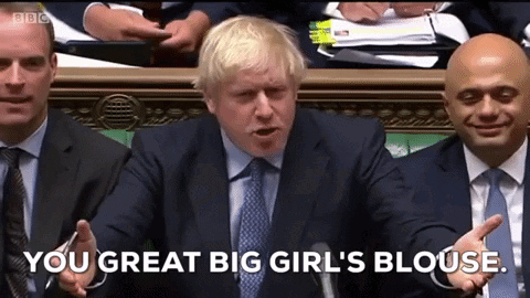 A Man In A Suit And Tie Is Talking Into A Microphone And Says " You Great Big Girl 'S Blouse " . GIF