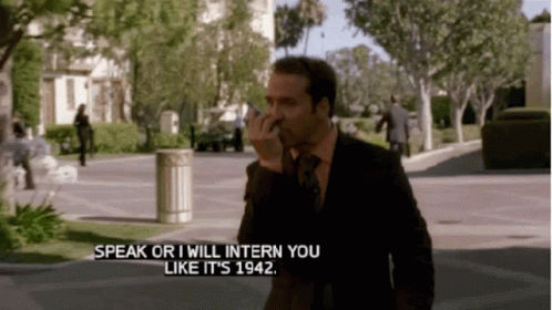 A Man In A Suit And Tie Is Talking On A Cell Phone And Says Speak Or I Will Intern You Like It Is 1942 GIF
