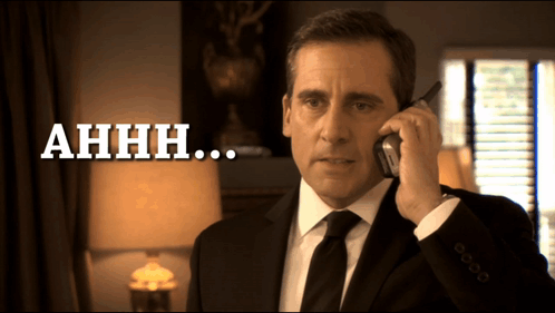 A Man In A Suit And Tie Is Talking On A Cell Phone And The Words Ahhh Are Below Him GIF