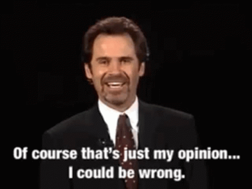 A Man In A Suit And Tie Is Talking On A Microphone . GIF