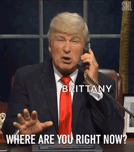A Man In A Suit And Tie Is Talking On A Phone With Brittany Where Are You Right Now Written Below Him GIF