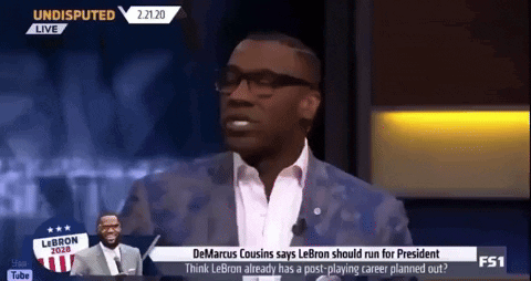 A Man In A Suit And Tie Is Talking On A Television Show GIF
