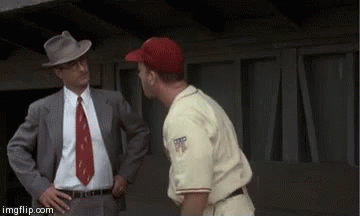 Man In Suit Talking To Baseball Player In Red Hat GIF