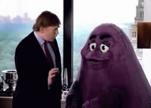A Man In A Suit And Tie Is Talking To A Purple Monster In Front Of A Window . GIF