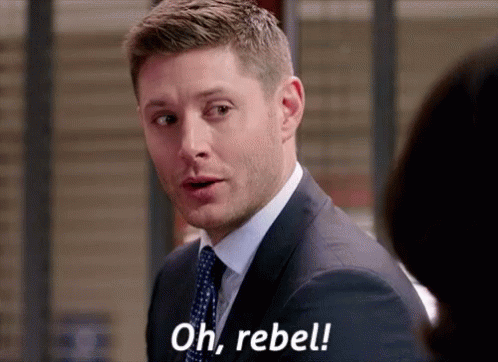 A Man In A Suit And Tie Is Talking To A Woman And Saying `` Oh , Rebel '' . GIF