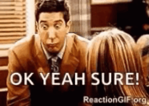 A Man In A Suit And Tie Is Talking To A Woman And Says Ok Yeah Sure GIF