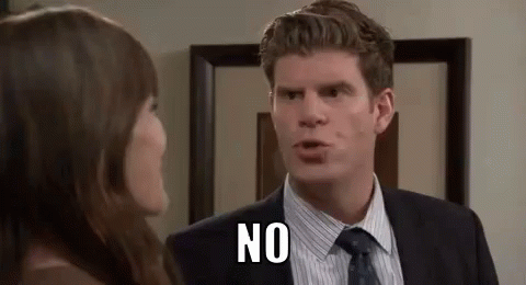 A Man In A Suit And Tie Is Talking To A Woman In A Room And Saying No . GIF