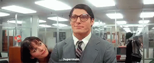 A Man In A Suit And Tie Is Talking To A Woman In An Office Who Is Looking At Him . GIF