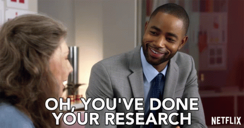 A Man In A Suit And Tie Is Talking To A Woman With The Words Oh You 'Ve Done Your Research On The Bottom GIF