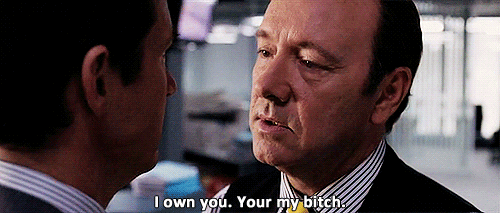 A Man In A Suit And Tie Is Talking To Another Man And Says I Own You Your My Bitch . GIF