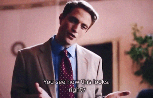 A Man In A Suit And Tie Is Talking To Another Man And Says " You See How This Looks Right " GIF