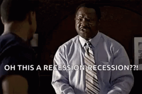 A Man In A Suit And Tie Is Talking To Another Man In A Room . GIF