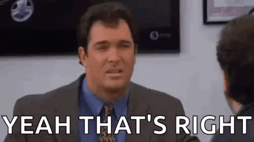 a man in a suit and tie is talking to another man in a room and saying `` yeah that 's right '' .