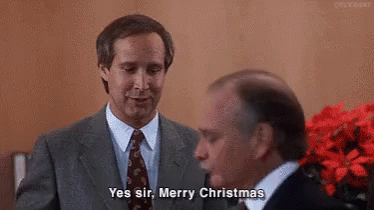A Man In A Suit And Tie Is Talking To Another Man In A Suit And Tie . GIF