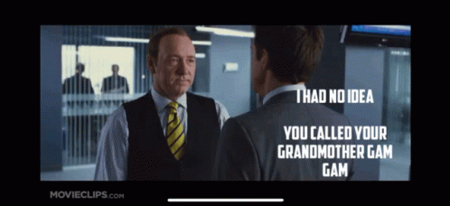 A Man In A Suit And Tie Is Talking To Another Man In A Suit And Vest GIF