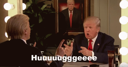 a man in a suit and tie is talking to another man in front of a painting of trump