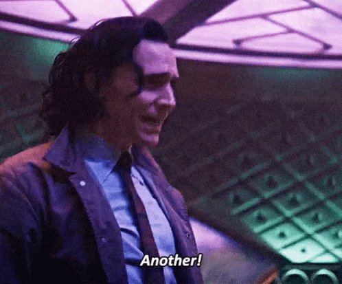 A Man In A Suit And Tie Is Talking To Another Person . GIF
