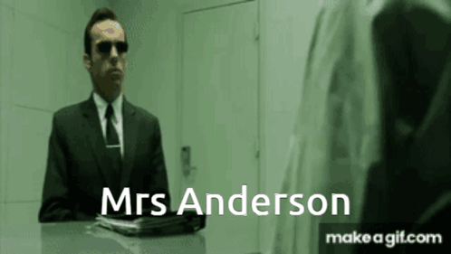 A Man In A Suit And Tie Is Talking To Mrs Anderson . GIF