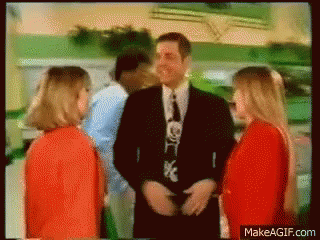 A Man In A Suit And Tie Is Talking To Two Girls GIF