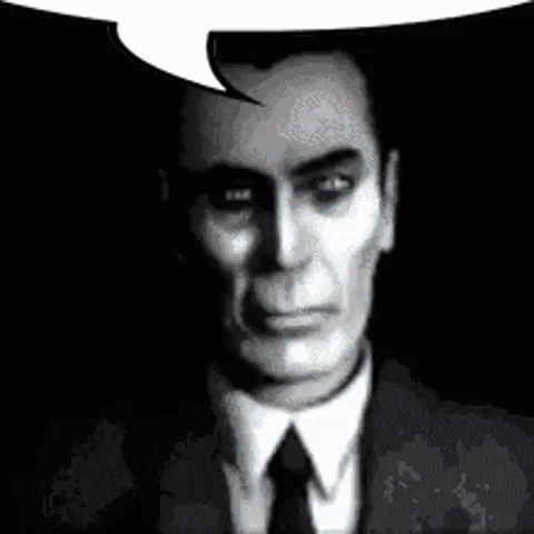 A Man In A Suit And Tie Is Talking With A Speech Bubble . GIF