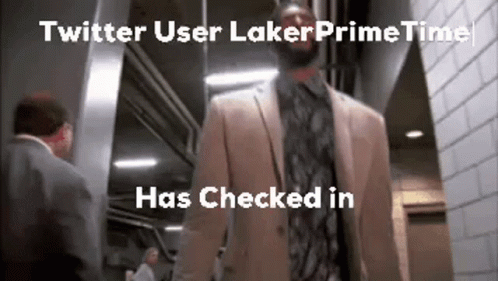 A Man In A Suit And Tie Is Walking Down A Hallway Next To A Man In A Suit And Tie . GIF