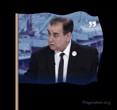 A Man In A Suit And Tie Is Waving A Flag That Says Flagmaker.org On It GIF