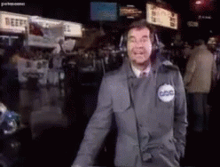 A Man In A Suit And Tie Is Wearing A Badge That Says Abc GIF