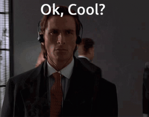A Man In A Suit And Tie Is Wearing A Headset And Says Ok Cool GIF