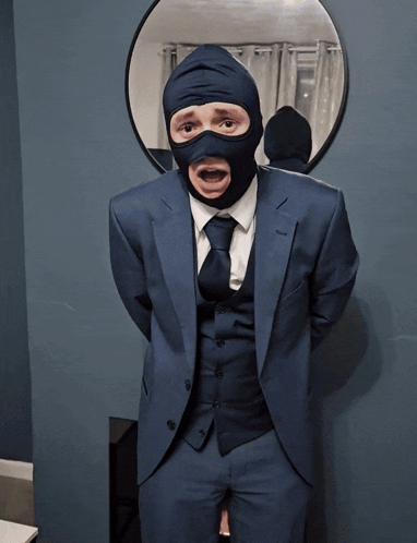 a man in a suit and tie is wearing a mask