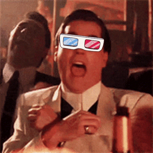 A Man In A Suit And Tie Is Wearing A Pair Of 3D Glasses On His Face GIF